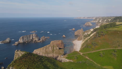 Aerial-View-Of-Beautiful-Wild-Cliff-Coastline-On-A-Sunny-Day-1