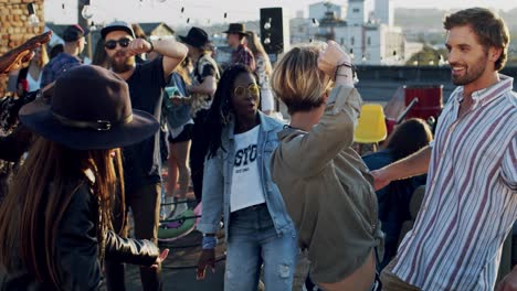 Young-Stylish-And-Attractive-Woman-With-Short-Blond-Hair-Dancing-With-Her-Friends-At-The-Rooftop-Party