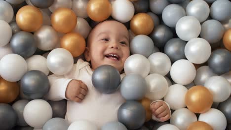 Adorable-Baby-Boy-Having-Fun-In-Ball-Pit