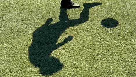 Close-Up-Of-A-Young-Soccer-Man-Training-Freestyle-Tricks-With-The-Ball-On-A-Street-Football-Pitch-On-A-Sunny-Day