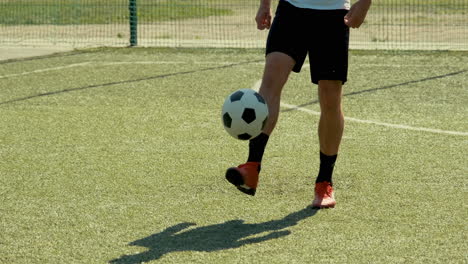 Close-Up-Of-An-Unrecognizable-Soccer-Player-Training-Freestyle-Tricks-With-The-Ball-On-A-Street-Football-Pitch-On-A-Sunny-Day-1