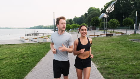 Happy-Couple-Running-Together-In-The-City-Near-A-River-1