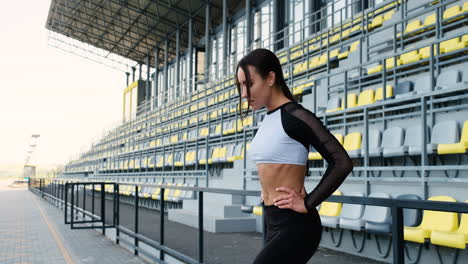 Beautiful-Sportive-Woman-Concentrating-Before-Outdoor-Exercise-In-The-Stadium-2