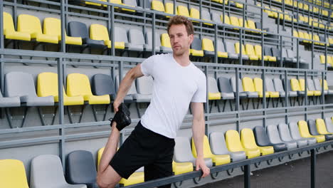 Fitness-Young-Male-Athlete-Doing-Stretching-Exercises-In-The-Stadium