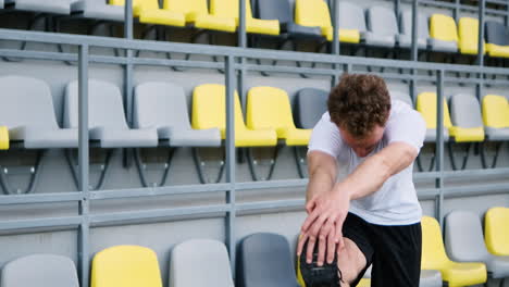 Fitness-Young-Male-Athlete-Doing-Stretching-Exercises-In-The-Stadium-1