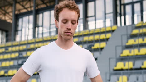 Fitness-Male-Athlete-Warming-Up-And-Stretching-Neck-In-The-Stadium