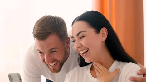 Close-Up-Of-A-Smiling-Couple-Having-A-Video-Call-On-Smartphone-At-Home-1