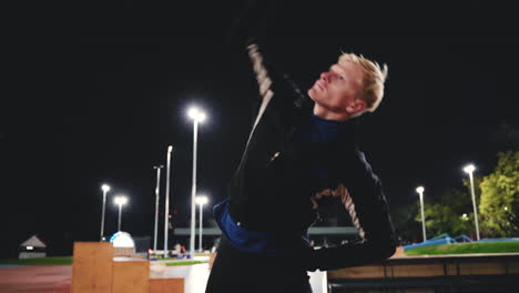 Sportive-Blond-Man-Doing-Stretching-Exercises-Before-Training-In-The-Park-At-Night-2