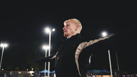 Sportive-Blond-Man-Doing-Stretching-Exercises-Before-Training-In-The-Park-At-Night-5