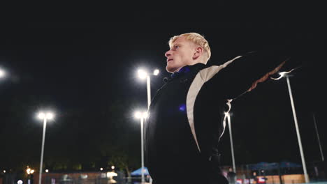 Sportive-Blond-Man-Doing-Stretching-Exercises-Before-Training-In-The-Park-At-Night-6