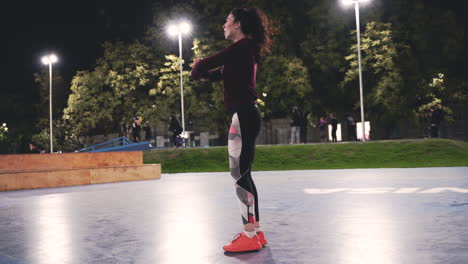 Sportive-Curly-Girl-Stretching-Legs-And-Doing-Lunges-In-The-Park-At-Night