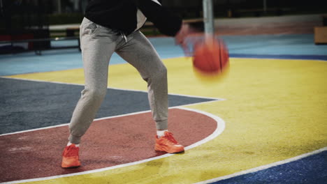 Close-Up-Of-A-Female-Basketball-Player-Training-With-Ball-On-Outdoor-Court-At-Night