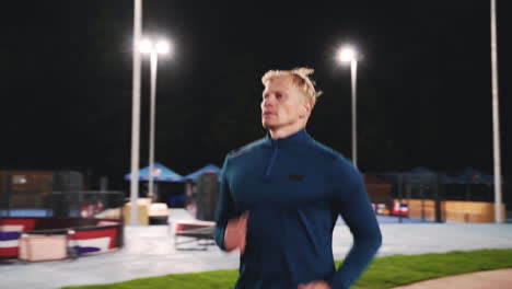 Focused-Blond-Man-Running-In-The-Park-At-Night-2