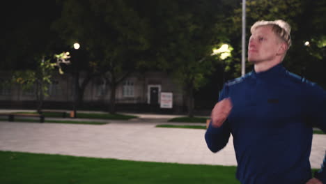 Focused-Blond-Man-Running-In-The-Park-At-Night-3