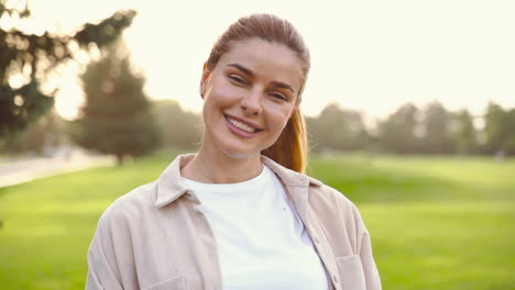 Portrait-Of-A-Beautiful-Woman-Smiling-And-Looking-At-Camera-In-The-Park
