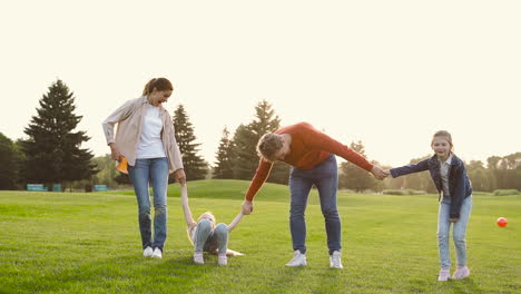 Happy-Family-Holding-Hands-And-Jumping-Together-In-The-Park