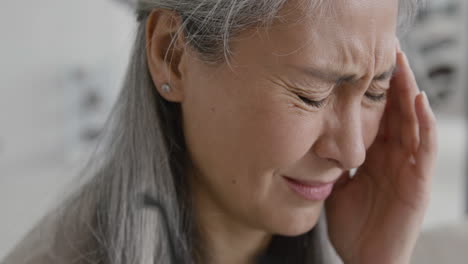 Close-Up-Of-Middle-Aged-Woman-Having-Headache-And-Touching-Her-Temples
