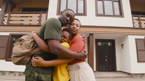 Parents-And-Son-Embracing-Each-Other-Outside-Home-Before-Army-Father-Going-To-Military-Service