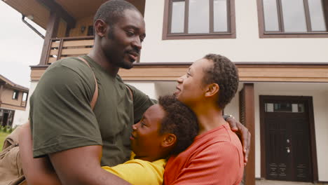 Portrait-Of-Parents-And-Son-Embracing-Each-Other-Outside-Home-Before-Army-Father-Going-To-Military-Service