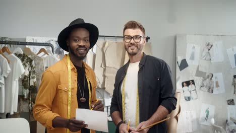 Young-And-Clothing-Designers-Working-Together-In-A-New-Collection-In-Studio-And-Smile-At-Camera