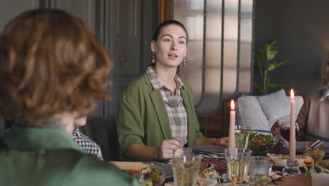 Woman-Talking-To-Her-Family-While-Having-Dinner-Together-At-Home