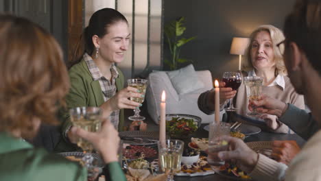 Happy-Family-Toasting-Each-Other-While-Having-Dinner-Together-At-Home-1