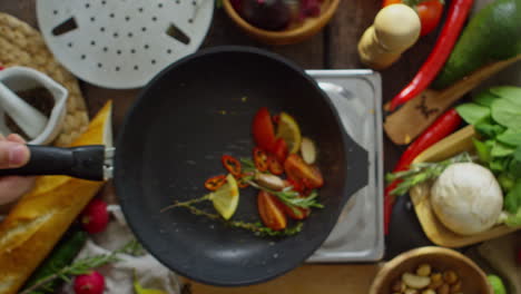 Top-View-Of-A-Frying-Pan-With-Vegetables-That-A-Cook-Moves
