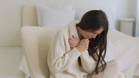 Sick-Woman-Coughing-Sitting-On-Chair-In-Bedroom-At-Home-1