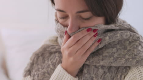 Sick-Woman-With-A-Warm-Scarf-Around-Neck-Having-Breath-Difficulties-At-Home