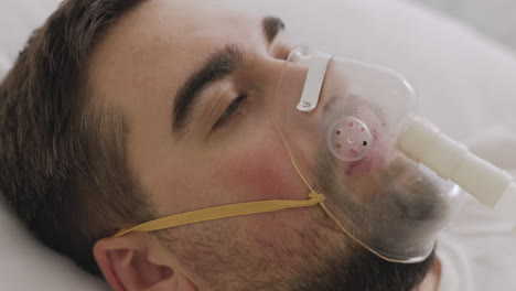 Sick-Man-Lying-On-Bed-Breathing-Through-Oxygen-Mask
