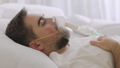 Sick-Man-Lying-On-Bed-Taking-His-Oxygen-Mask-Off-And-Coughing-1