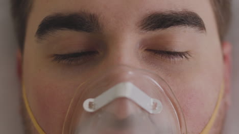 Close-Up-Of-A-Sick-Man-Lying-On-Bed-Breathing-Through-Oxygen-Mask-2
