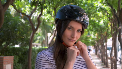 Portrait-Of-A-Beautiful-Young-Woman-Taking-Off-Her-Helmet-While-Smiling-At-Camera