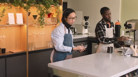 Two-Multiethnic-Waiters-Working-In-A-Coffee-Shop-3