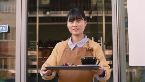 Waitress-Standing-Outside-The-Coffee-Shop,-Holding-Food-Tray-And-Smiling-At-Camera