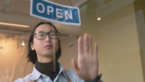 Waiter-Putting-An-Open-Sign-On-The-Coffee-Shop-Door-1