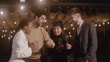 Group-Of-Happy-Multiethnic-Friends-Celebrating-New-Year-Countdown-Together-And-Toasting-With-Champagne-Glasses