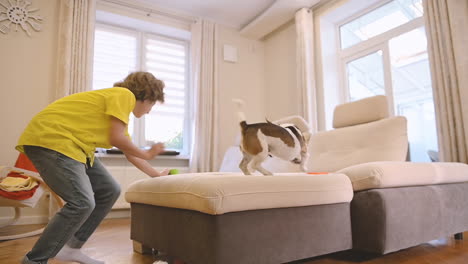Blond-Boy-Playing-With-His-Dog-In-The-Living-Room