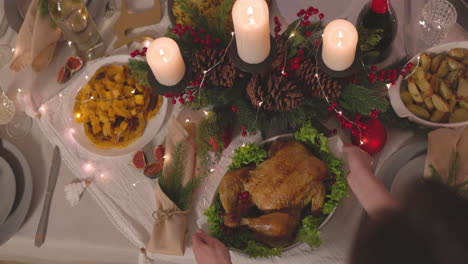 Unrecognizable-Woman-Putting-Roast-Chicken-On-Christmas-Dinner-Table-2