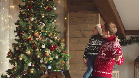 Happy-Father-And-Daughter-Having-Fun-And-Dancing-Near-Christmas-Tree-At-Home