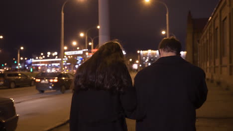 Rear-View-Of-A-Couple-Hugging-While-They-Walking-In-The-Street-After-The-New-Year's-Party