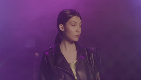 Beautiful-Girl-In-Leather-Jacket-Looking-Confidently-At-Camera-At-Disco