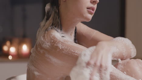 Side-View-Of-A-Woman-Taking-A-Bath-While-Rubbing-Her-Back-And-Arms-With-Soap-1