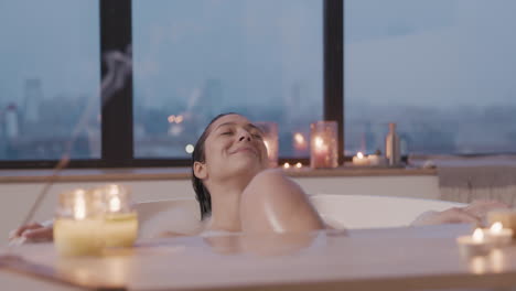 Close-Up-View-Of-Candles,-In-The-Background-A-Woman-Taking-A-Bath-In-A-Bathtub-1