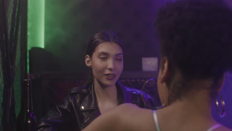 Beautiful-Girl-With-Braces-Talking-To-Her-Friend-At-Disco