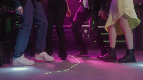 Close-Up-Of-Legs-Of-Four-Unrecognizable-People-Dancing-At-Disco-Club