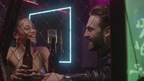Beautiful-Girl-And-Bearded-Man-Talking-And-Laughing-Together-At-Disco
