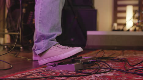 Close-Up-Of-An-Unrecognizable-Man-Playing-Electric-Guitar-And-Pressing-Effects-Pedal