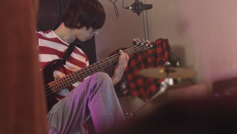 Energetic-Boy-Playing-Guitar-During-A-Rehearsal-In-Recording-Studio