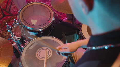 Unrecognizable-Energetic-Musician-Playing-Drums-During-A-Band-Rehearsal-In-Recording-Studio
